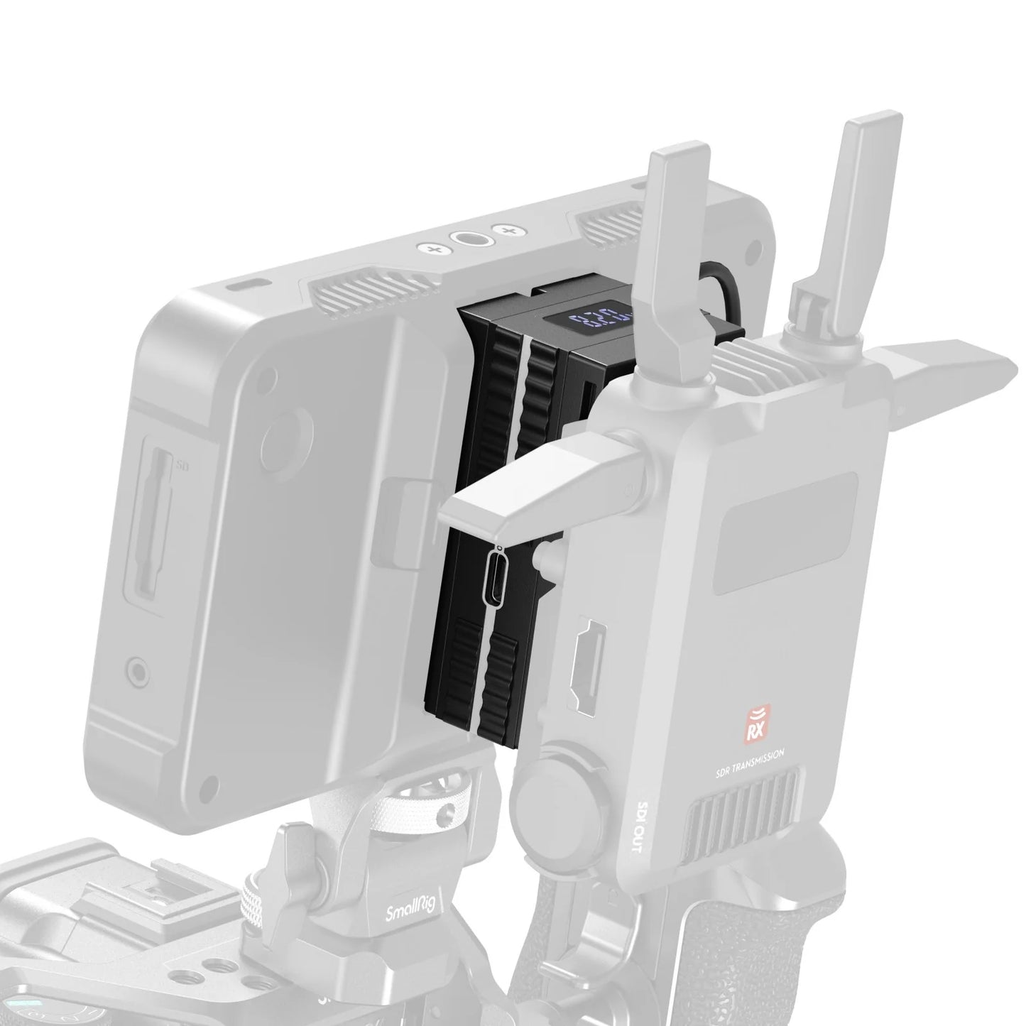 Close-up of the SmallRig dummy battery adapter mounted between a wireless video receiver and monitor.