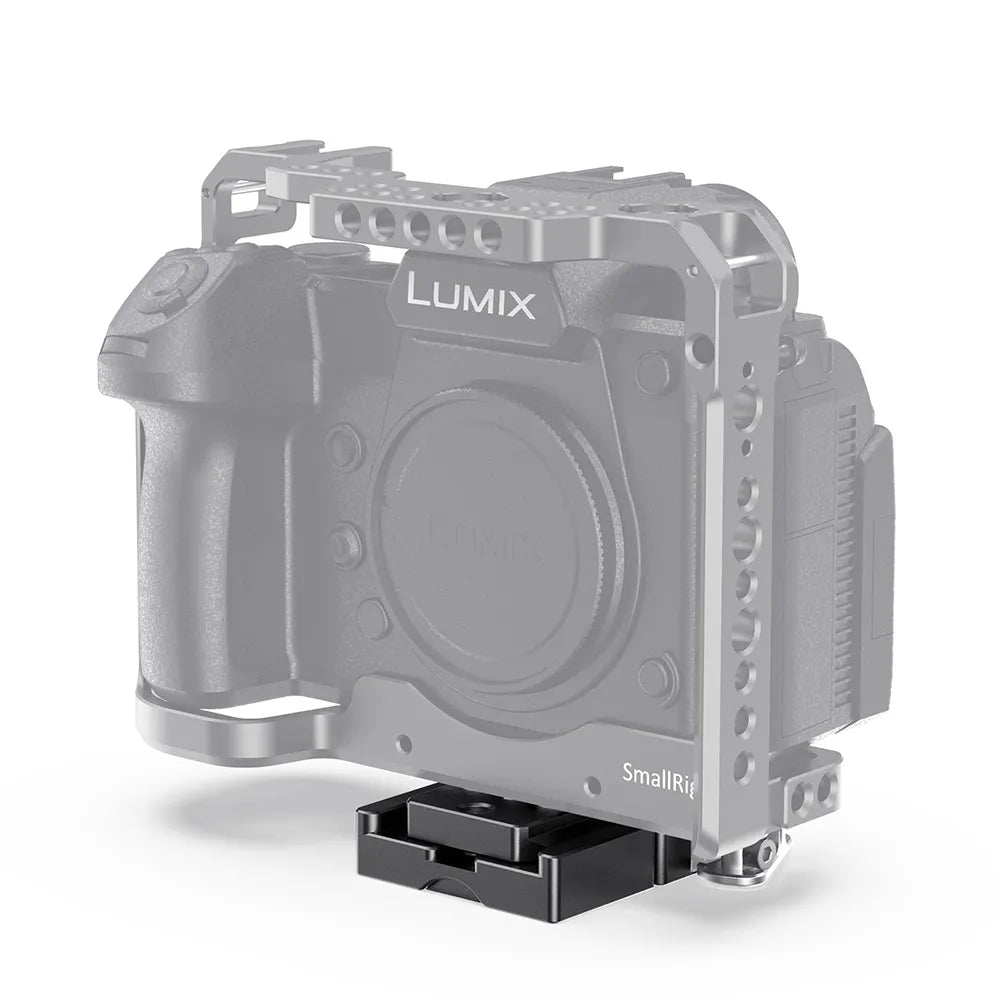 Quick release clamp mounted under a camera cage for fast tripod transitions.