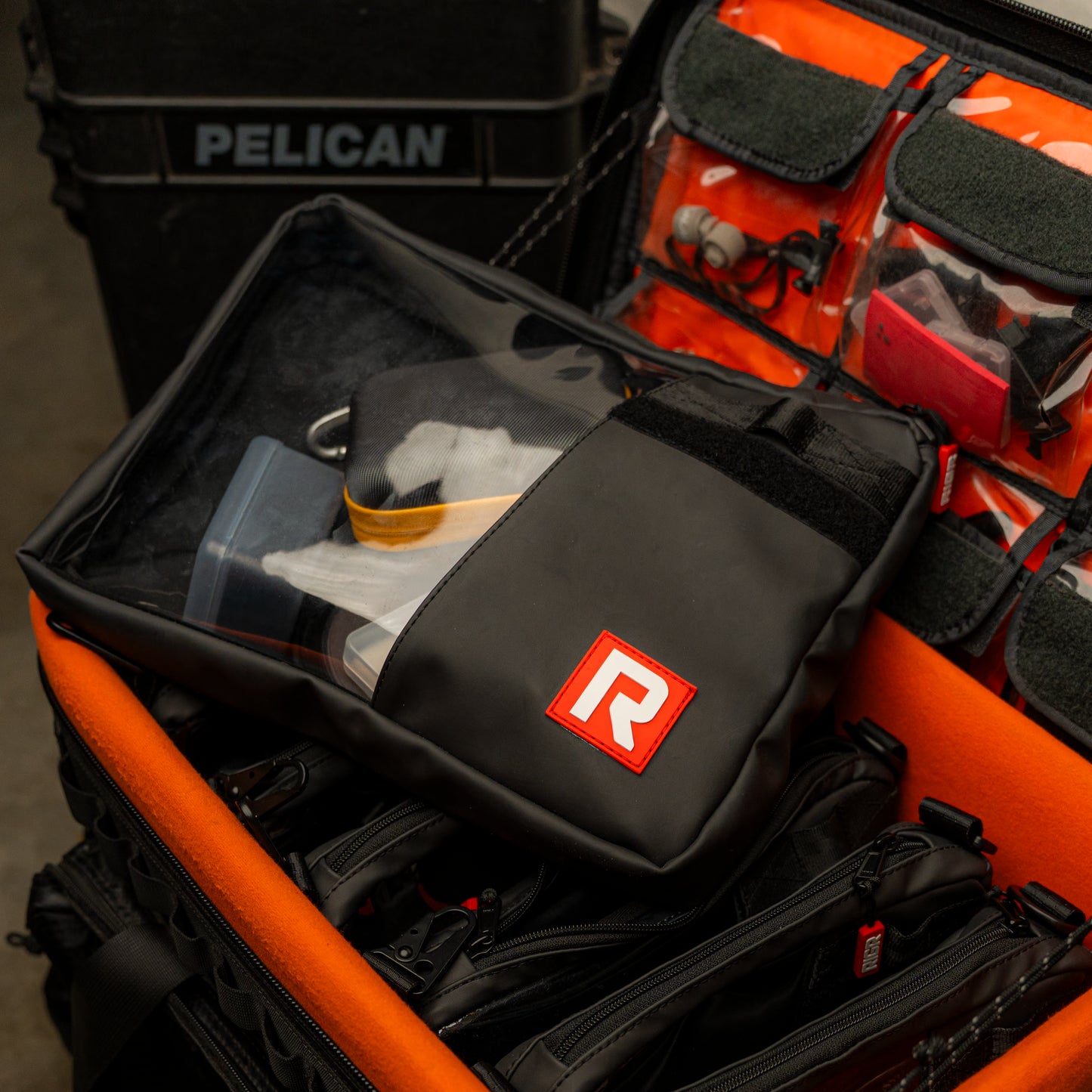 RIGR StackPak on an Brighttangerine Loader bag packed with camera gear, with a pelican case in the background