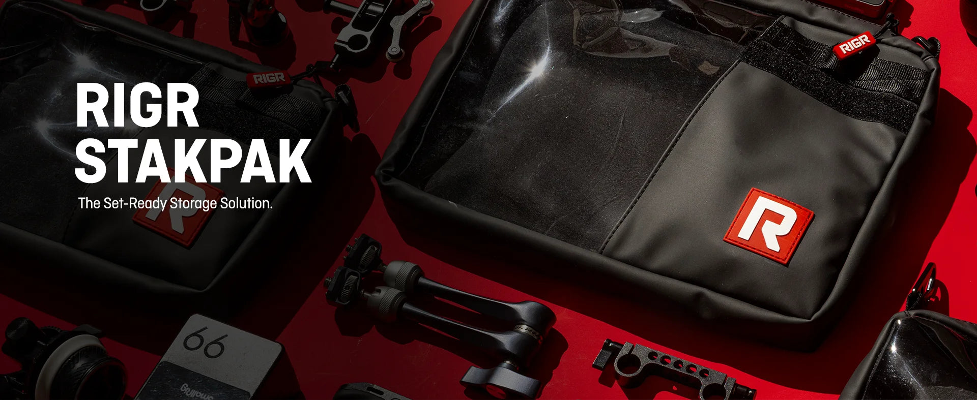 RIGR StakPak organisational bags displayed on a red surface surrounded by SmallRig filmmaking gear and camera rig accessories.