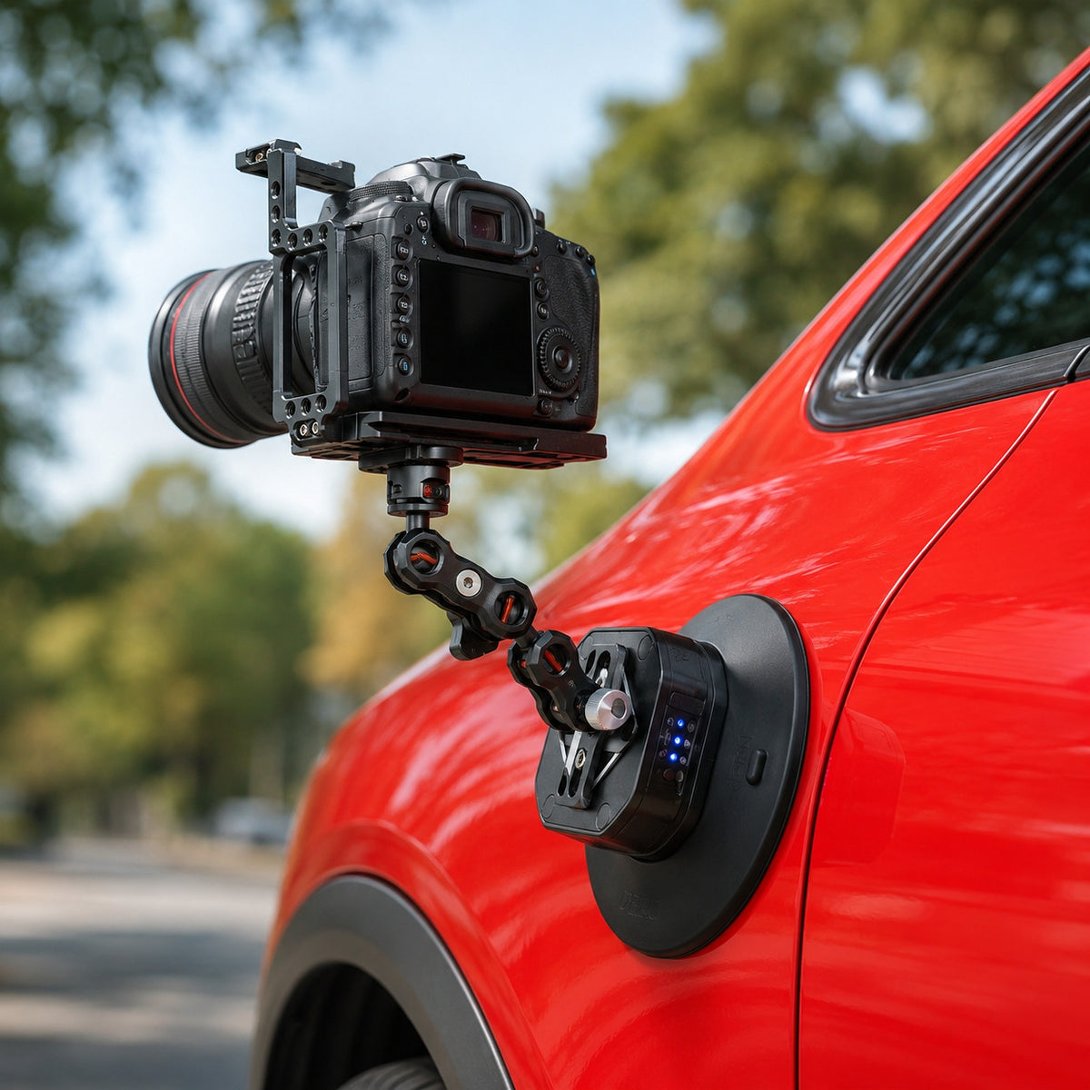 DigitalFoto SNIPER-EPUCK6 electric suction cup mounted on a red car door with magic arm and cinema camera rig