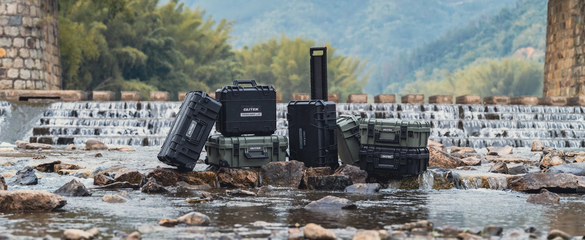 Gutek hard cases in river scene under bridge highlighting rugged waterproof protection
