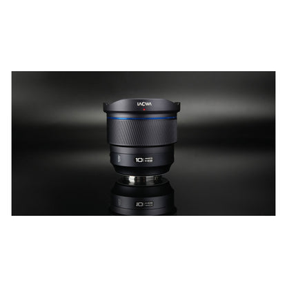 Laowa 10mm f/2.8 with front cap and mount ring reflected on dark background, shot vertically.