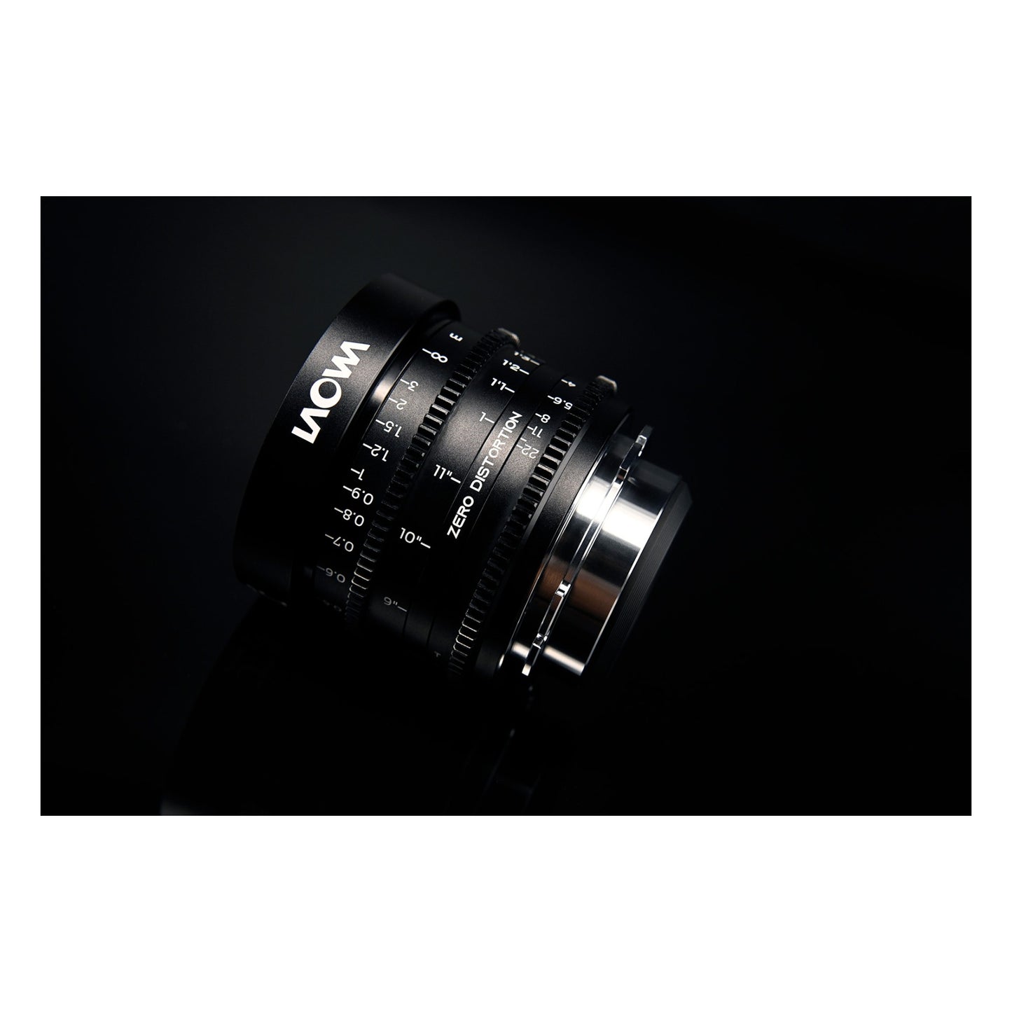Laowa 14mm T2.6 angled 3/4 view against dark background with LAOWA branding and Zero-D text visible, dramatic sidelighting on mount.