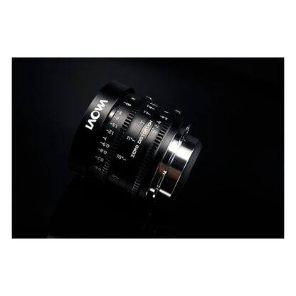 Laowa 14mm T2.6 angled 3/4 view against dark background with LAOWA branding and Zero-D text visible, dramatic sidelighting on mount.