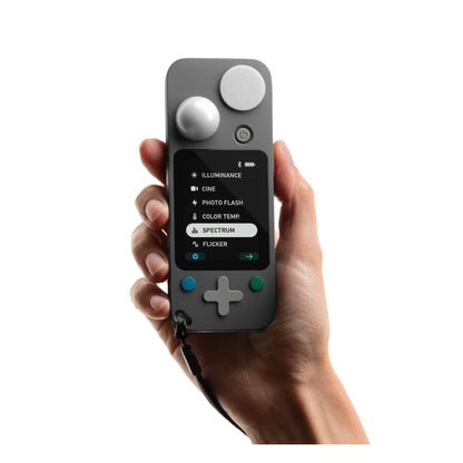Hand holding Lit Duo 1 at mid-body height against white background, front-facing with spectrum menu option highlighted on screen.