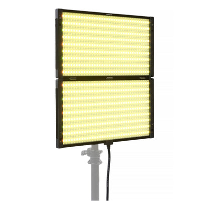 Two stacked PavoSlim 240C panels emitting warm yellow-tungsten light, demonstrating dual-unit modular setup and color temperature control.