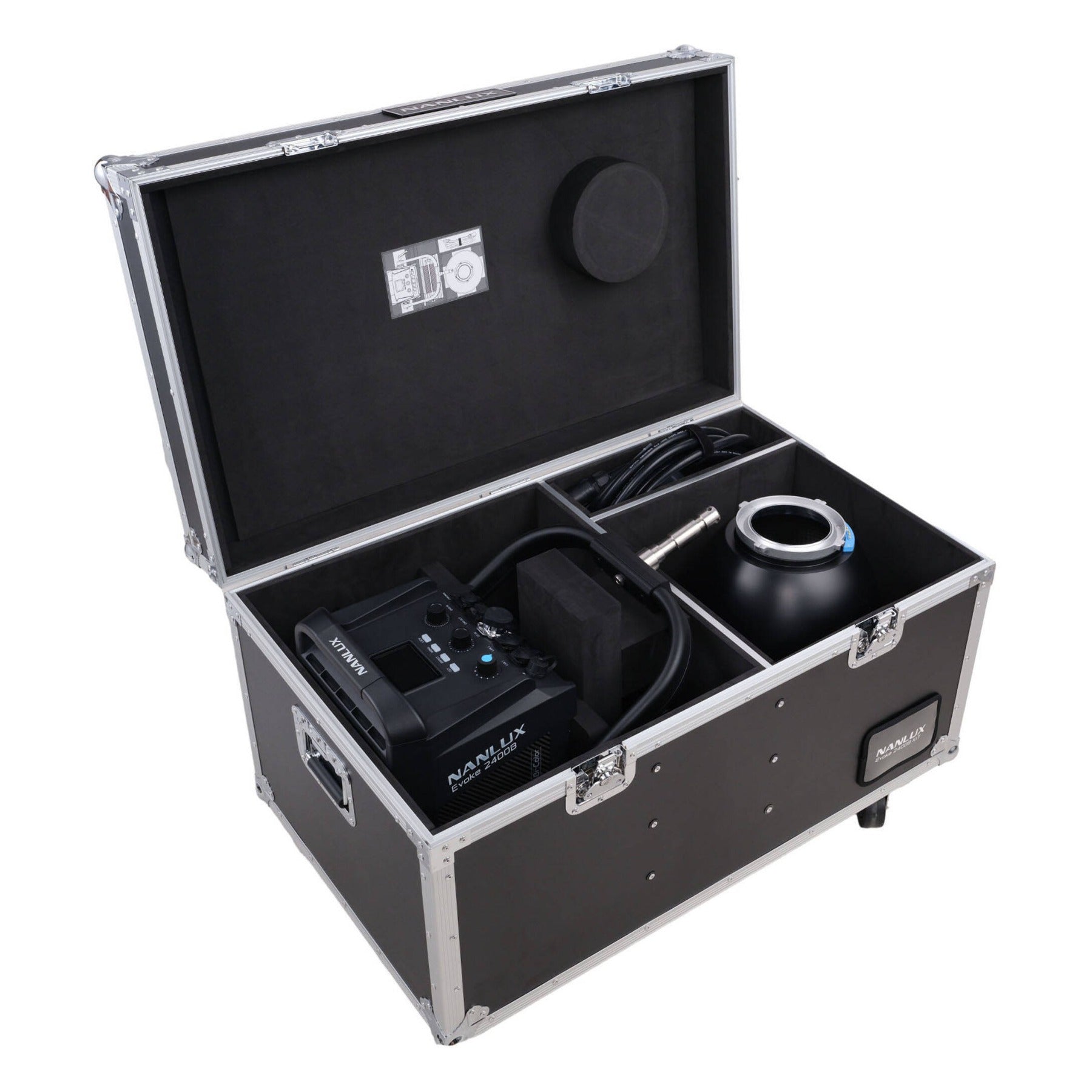 Flight case opened flat showing interior compartments with the Evoke 2400B light, control unit, cables, reflector, and foam padding layout.