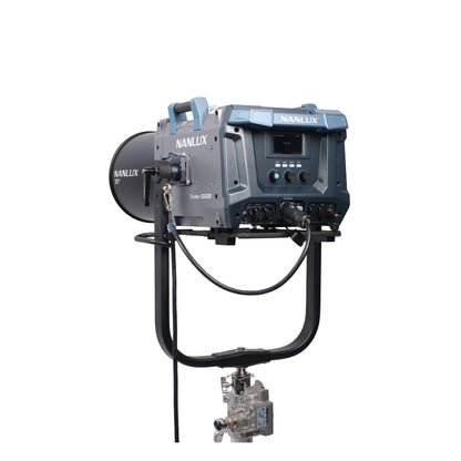 NANLUX Evoke 5000B with 30° lens attachment mounted on stand, photographed from the rear to show the control panel, back connectors, and cable routing alongside the focused lens optic.