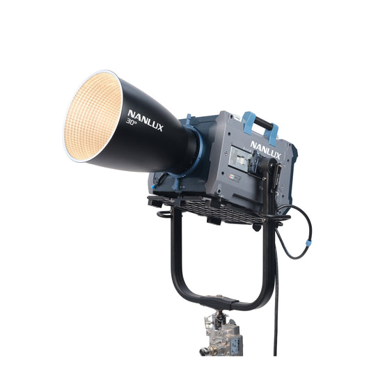 NANLUX Evoke 5000B with conical reflector attachment lit and emitting warm light, revealing the honeycomb grid pattern on the reflector's inner surface, mounted on stand.
