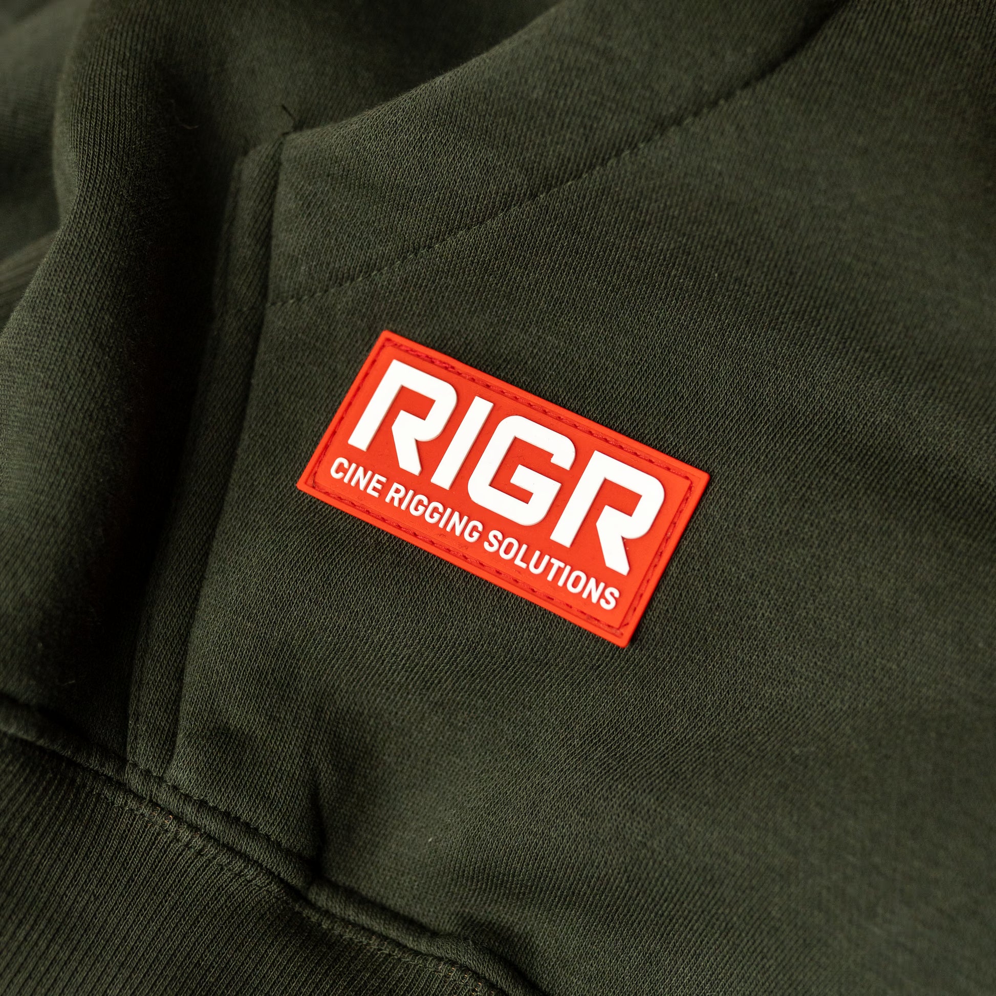 RIGR pocket badge detail on forest green heavyweight hoodie